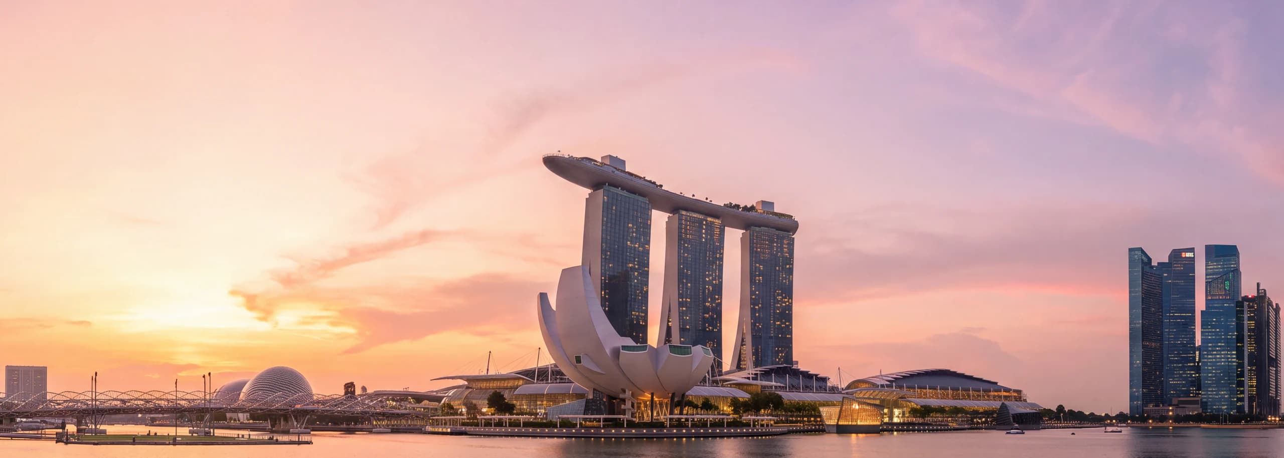 Singapore skyline across Marina Bay at sunset, with Marina Bay Sands and the ArtScience Museum